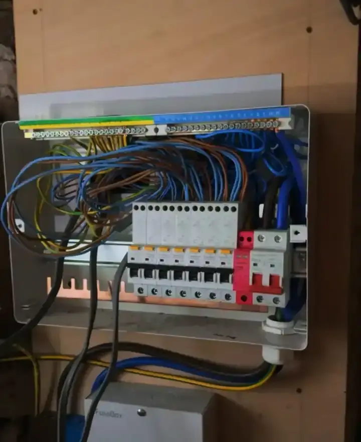 Consumer unit with tangled, undressed wiring, as found before FM Electrical took it over
