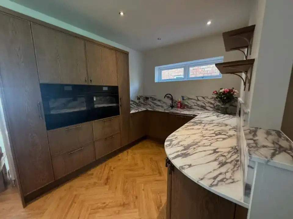 Finished kitchen in Handforth with marble worktops, built-in ovens and new downlights